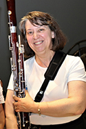 A picture of Rene Sanders holding her bassoon.