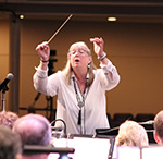 A picture of Sandra Stoeckel conducting the band.