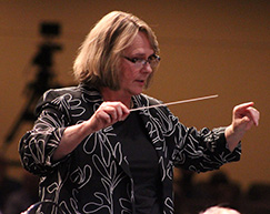 A picture of Carol Commerford conducting.