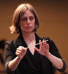 A picture of Morgan Schneider conducting.